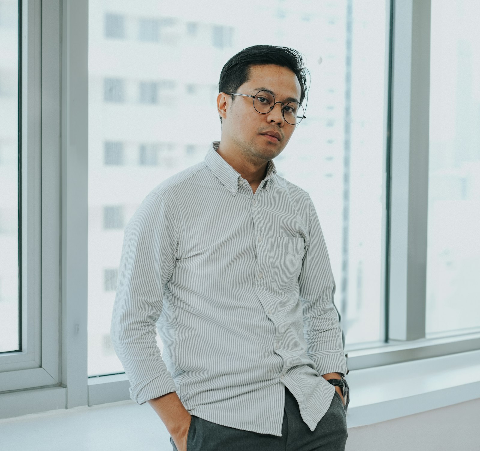 An executive standing by the office window