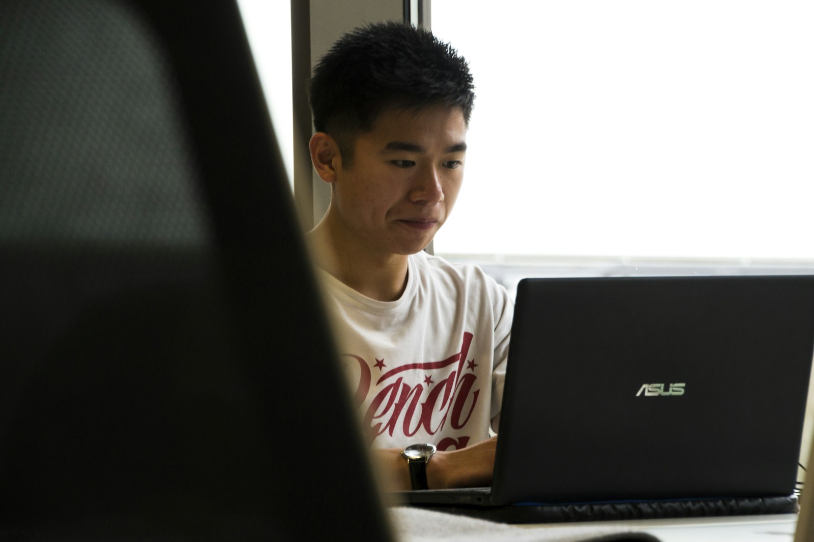 An Asian engineer working on a laptop