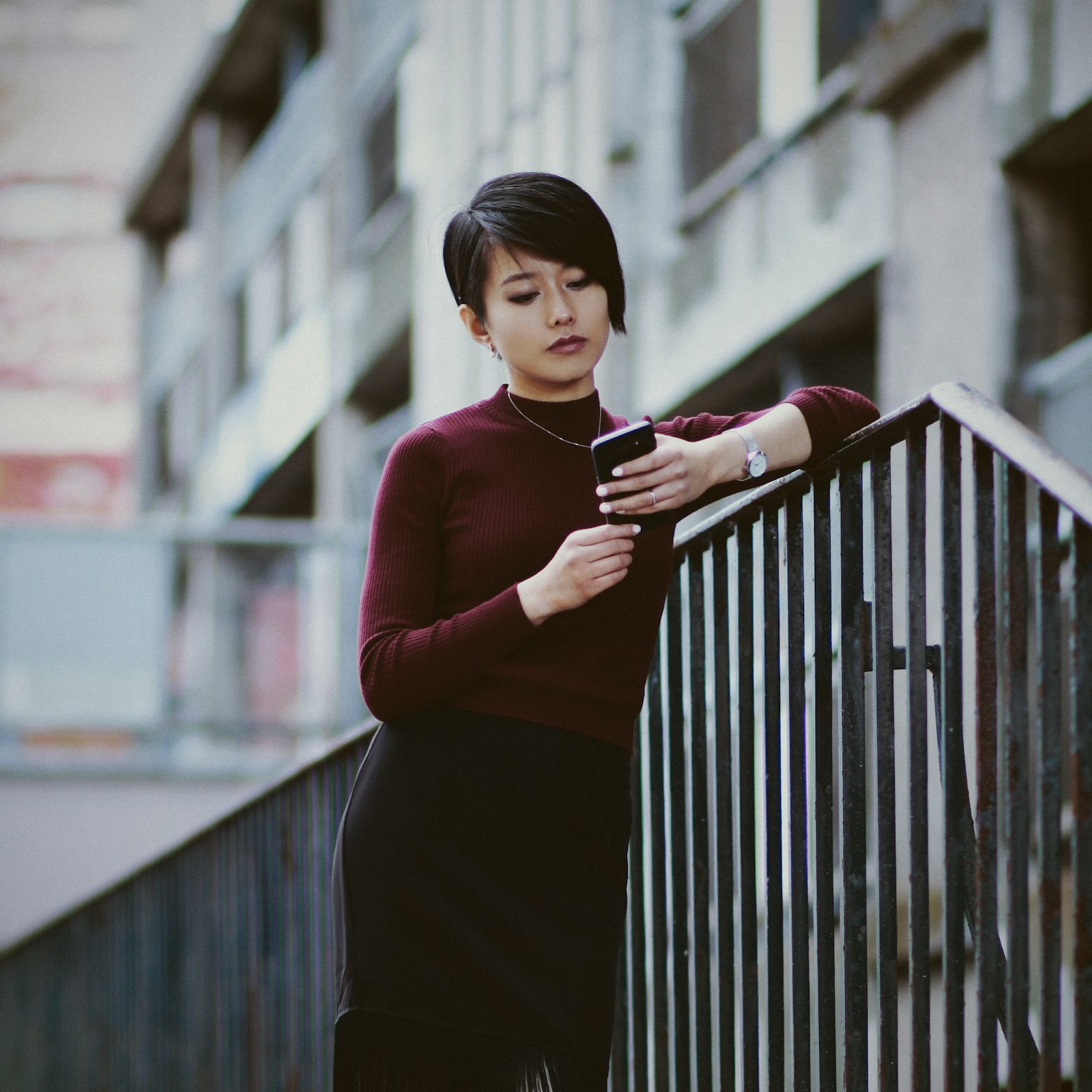 An Asian woman looking at her mobile phone