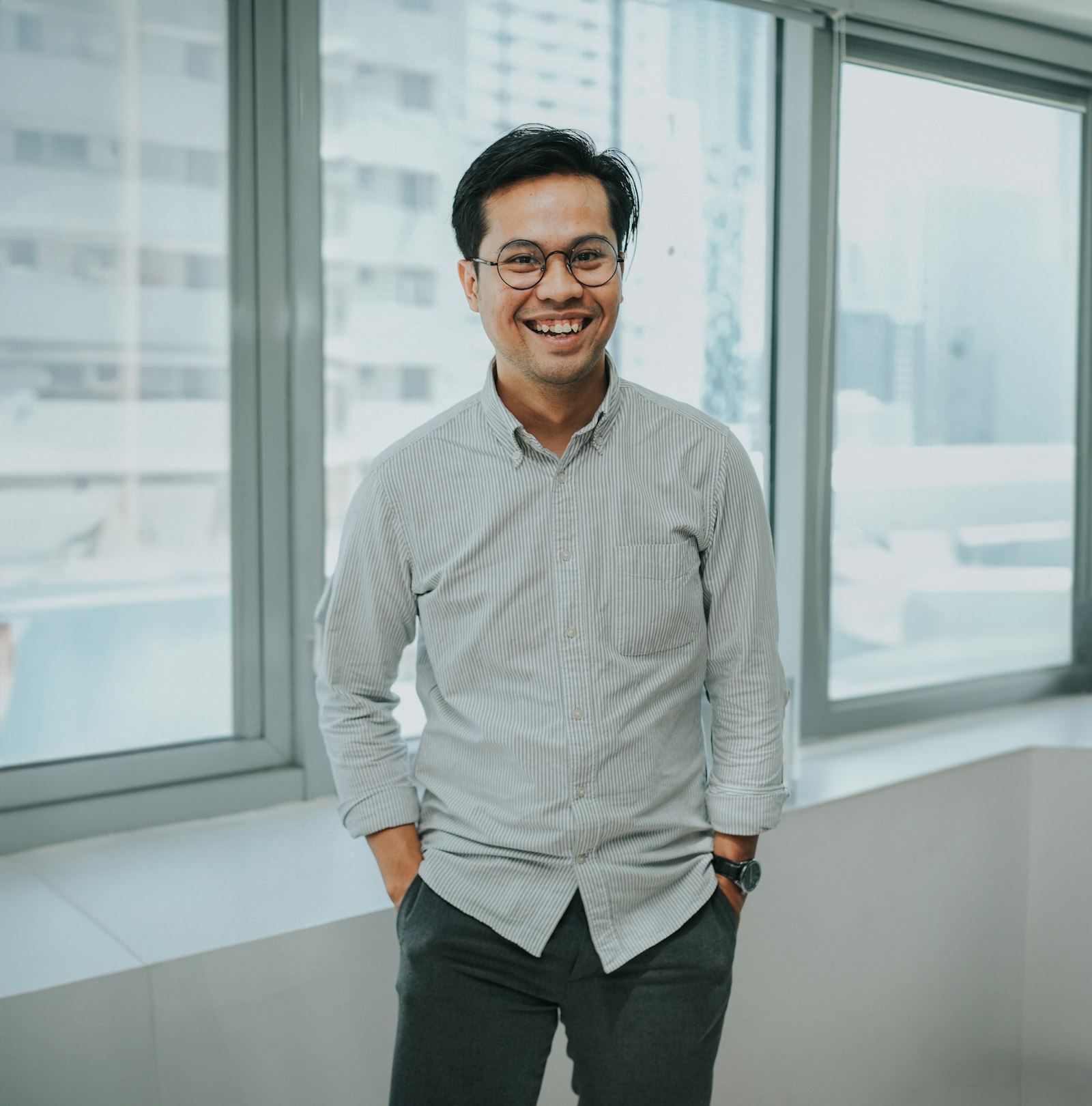 A smiling Asian businessman in an office
