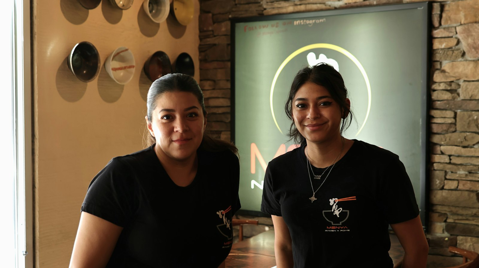 Two Asian women working in a restaurant